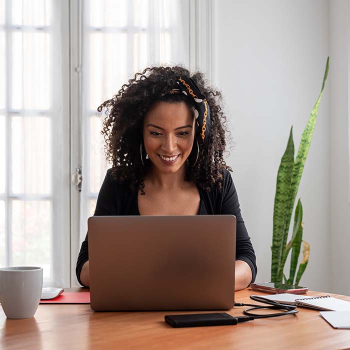smiling woman choosing a domain on her laptop