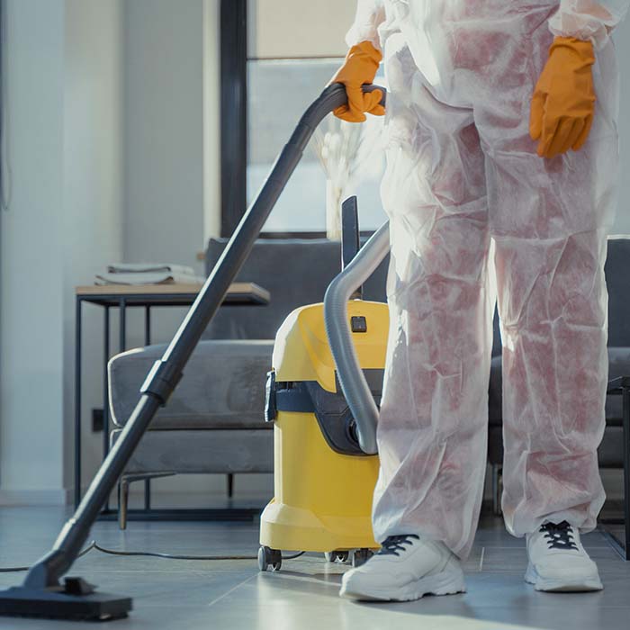 Cleaner vacuuming a floor