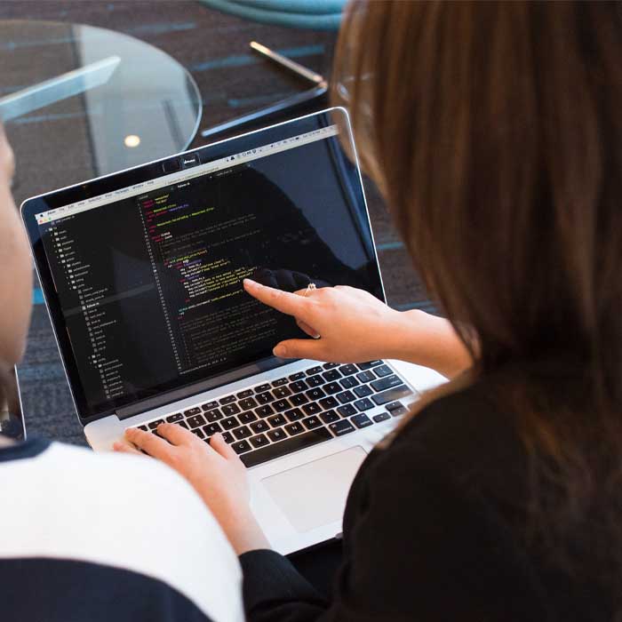 Developer going through code on a laptop