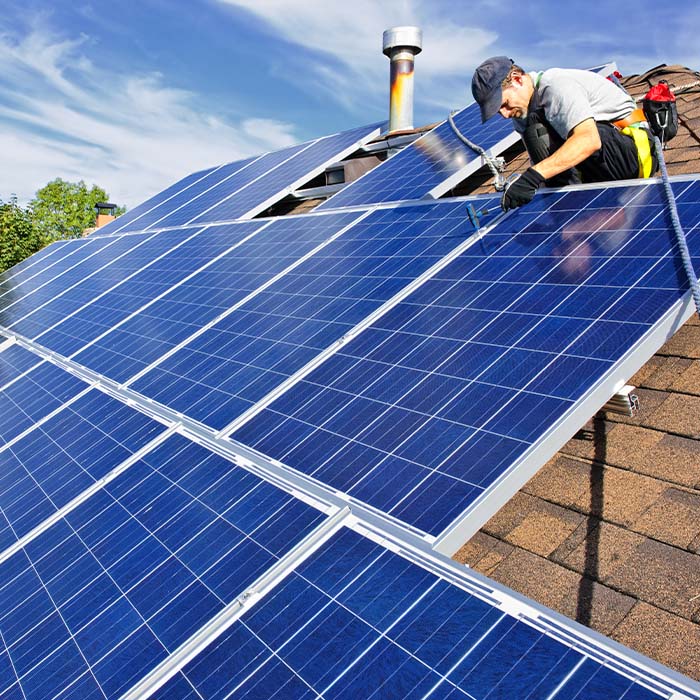 a technician installing solar panels