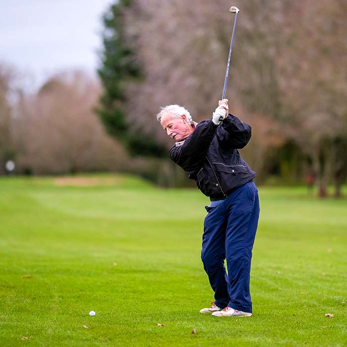 an elderly gentleman playing a round of golf