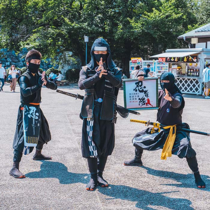 three ninja's posing in the street